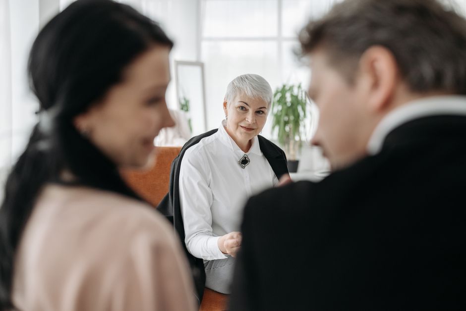 A professional consultation session with a couple and a social worker in a modern office environment